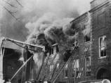 Another view of firefighting efforts in the alley on the north side of the school. By the time this picture was taken, everyone remaining in the second floor classrooms was already dead.