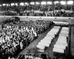 The front rows nearest the coffins were reserved for the families of the 27 young victims whose coffins stretched before them. The Illinois National Guard Armory was chosen for the service because the church had no facilities large enough to accomodate the anticipated crowd. Nearly 7,000 mourners filled the building to capacity for the service. (Photo courtesy of Witold “Vic” Szmyd)