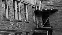 The exit from the school annex to the small courtyard between the north and south wings of the school can be seen here. The canopy over this exit helped students in room 209 above escape, resulting in just two deaths in that classroom.