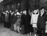 Anxious parents and relatives rushed to the fire scene to await news of their sons and daughters, brothers and sisters. All who stood outside the school that day witnessed unspeakable horrors none would soon forget, though few would discuss. (Photo courtesy of The Catholic New World with photo research by Renee Jackson)
