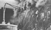 The Chicago Fire Department snorkel is working the blaze in room 210, as a fireman climbs a ladder to one of room 212 windows. No children are hanging out of windows as they had been just minutes earlier, because everyone still inside the doomed classrooms is now dead or nearly dead.