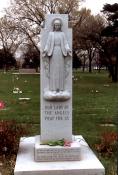 Our Lady of the Angels, the Virgin Mary, watches over the simple, flat grave markers of 25 of the students who died as a result of the school fire. The inscription at the base of the statue reads, “In devout memory of the victims of the fire, December 1, 1958, at Our Lady of the Angels school. Erected by the Parishioners, the Priests, the Sisters and their Pastor, the Rt. Rev. Msgr. Joseph E. Cussen.” (Photo courtesy of Renee Jackson)