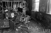 This is room 210, looking at a pile of charred desks that were moved out of the way during the recovery of bodies. The hole that firemen punched in the wall from room 212 next door can be seen just beyond the debris. This was a fourth grade classroom, where the youngest and smallest victims of the fire perished. (Life Magazine Photo)