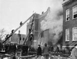 Smoke is billowing from the west stairway window and door, and from room 211 where 24 children lie dead.